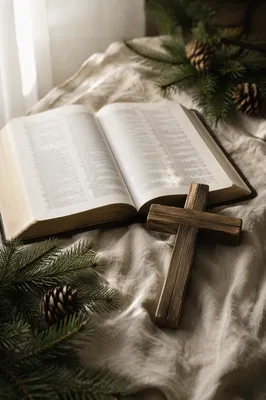 Open Bible and Wooden Cross on Linen