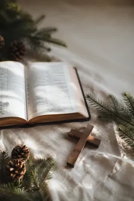 Open Bible and Wooden Cross on Linen