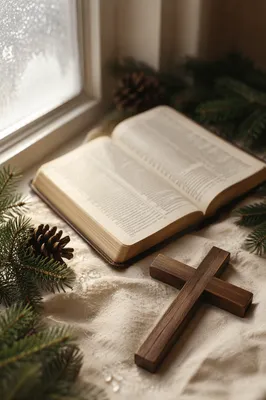 Open Bible and Wooden Cross with Evergreen