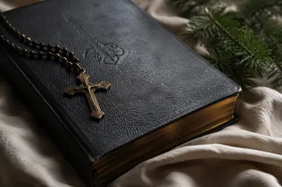 Bible and Bronze Cross on Linen