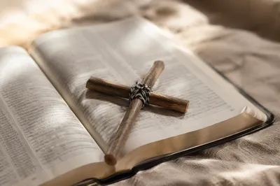 Twig Cross on Open Bible and Linen