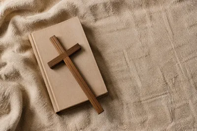 Bible and Wooden Cross on Linen