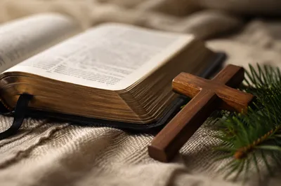 Bible and Wooden Cross on Linen