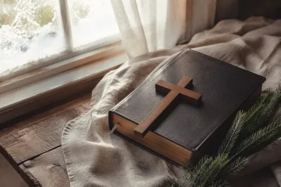 Bible and Wooden Cross on Linen