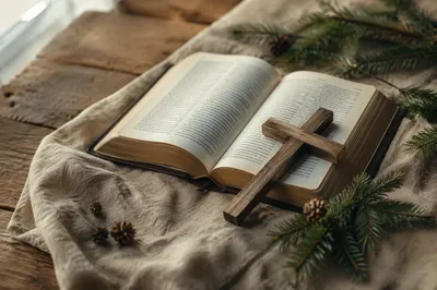 Open Bible and Wooden Cross on Linen