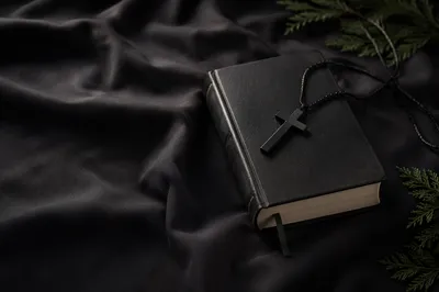 Black Bible and Cross on Linen