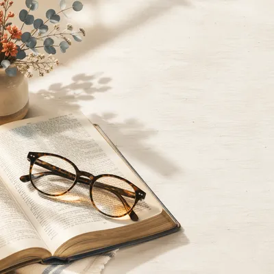 Open Bible with Reading Glasses in Warm Light