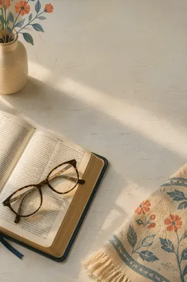 Open Bible with Glasses in Warm Light