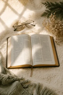 Open Bible with Glasses in Warm Light
