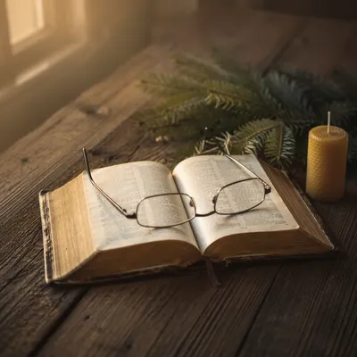 Open Bible With Glasses in Warm Light