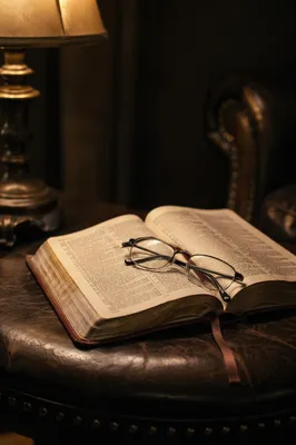 Open Bible with Reading Glasses in Warm Light