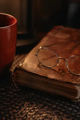 Closed Bible with Reading Glasses and Mug