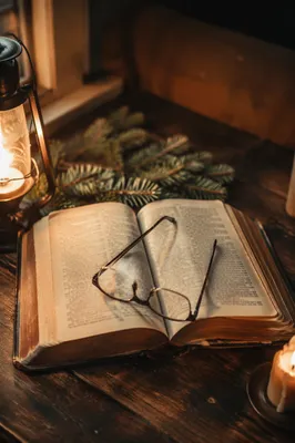 Open Bible with Glasses in Warm Light
