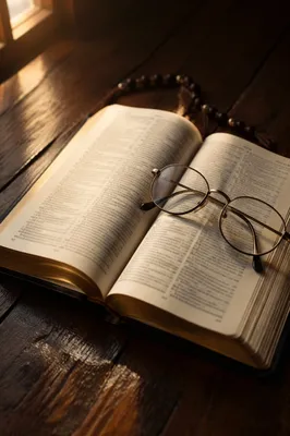 Open Bible with Reading Glasses in Warm Light