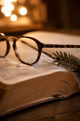 Open Bible with Glasses in Warm Light