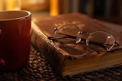 Closed Bible with Glasses and Mug