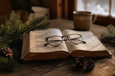 Open Bible with Reading Glasses in Warm Light