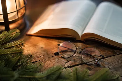Open Bible with Reading Glasses in Warm Light