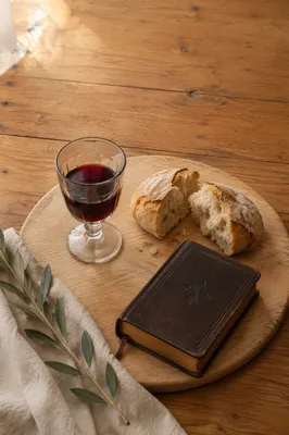 Communion Bread and Wine on Walnut Table