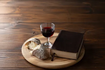 Communion Bread and Wine on Walnut Table