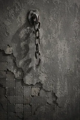 Broken Rusted Chains on Weathered Wall