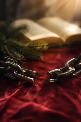 Broken Chains on Crimson Fabric at Dawn
