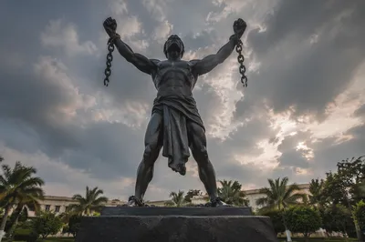 Broken Chains Freedom Monument Under Stormy Sky