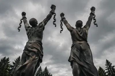 Broken Chains Freedom Monument Under Stormy Sky