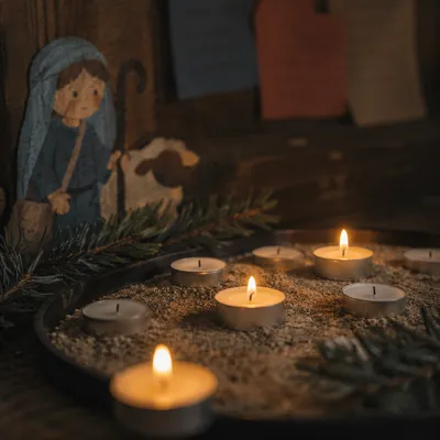Burning Tea Lights in Quiet Chapel Shadows