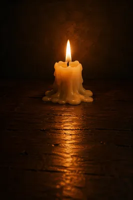 Single Burning Candle on Dark Table