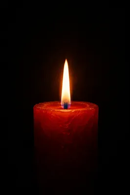 Red Candle Flame in Sacred Darkness