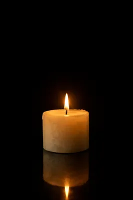 Burning Ivory Candle in Quiet Darkness
