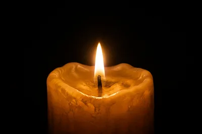 Golden Candle Flame in Quiet Darkness
