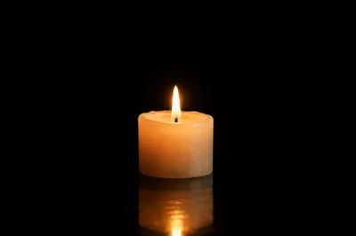 Burning Ivory Candle in Quiet Darkness