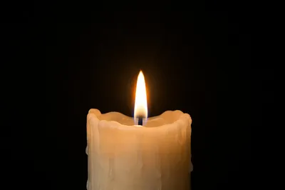 Burning Ivory Candle in Quiet Darkness