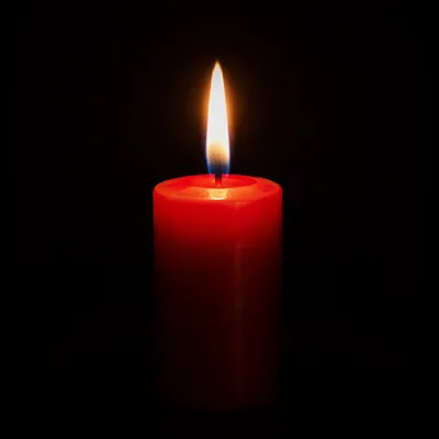 Red Candle Flame in Quiet Darkness