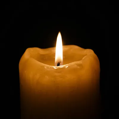 Burning Golden Candle in Quiet Darkness