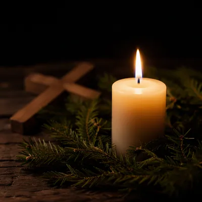 Burning Candle with Evergreen Faith Cross