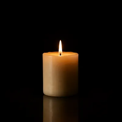 Burning Ivory Candle in Quiet Darkness