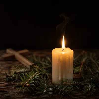Burning Candle with Evergreen Faith Cross