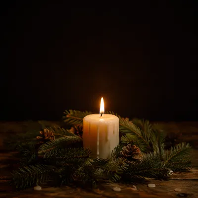 Burning Ivory Candle with Evergreen Wreath