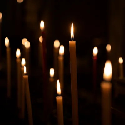 Burning Candles in Quiet Faithful Darkness