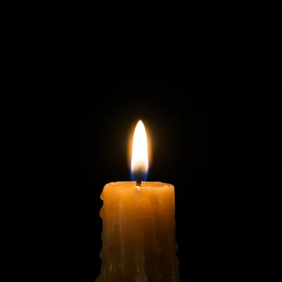 Burning Candle in Dark Faith Background