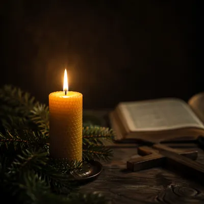 Burning Candle With Evergreen and Cross
