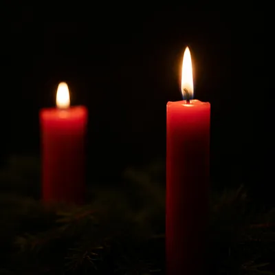 Two Red Candles on Dark Background