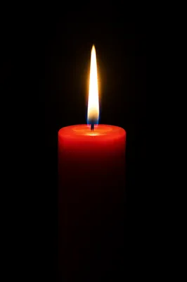 Red Candle Flame in Quiet Darkness