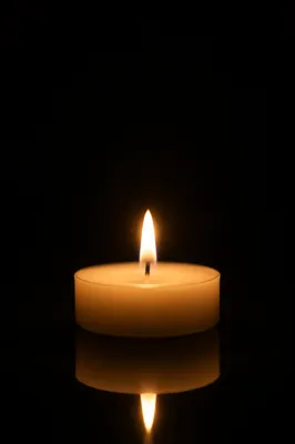 Burning Ivory Candle in Quiet Darkness
