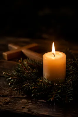 Burning Candle with Evergreen and Wooden Cross