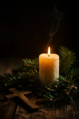 Burning Candle with Evergreen and Cross