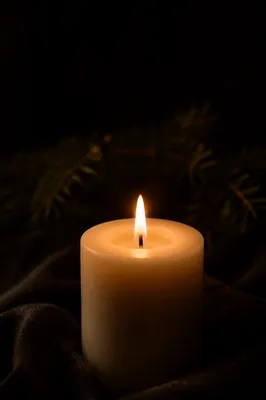 Burning Ivory Candle in Winter Darkness
